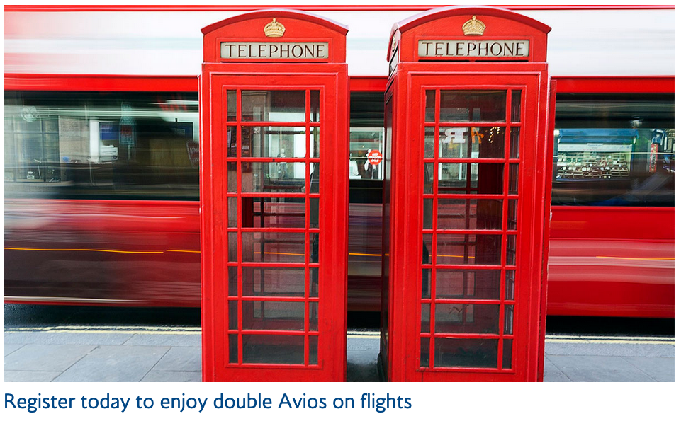 a red telephone booth next to a train