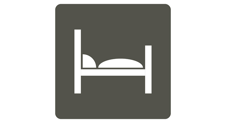 a white and gray sign with a bed