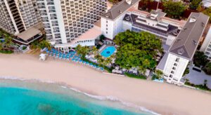 a beach with a swimming pool and a building