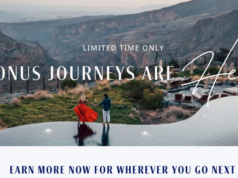 a man and woman standing on a ledge with a view of the canyons