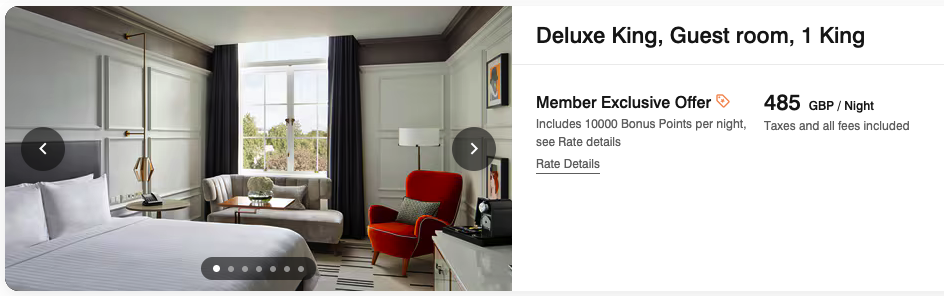 a room with a red chair and a lamp